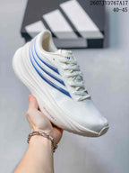 Close side view of a white Adidas sneaker showing layered blue side panels and a textured upper.