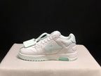 Side profile showing the low-top silhouette, layered stitched panels, decorative hangtag and pale mint outsole sections.