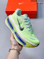 Angled side view of a lime-green Nike Vomero Premium running shoe with dark Swoosh accents.