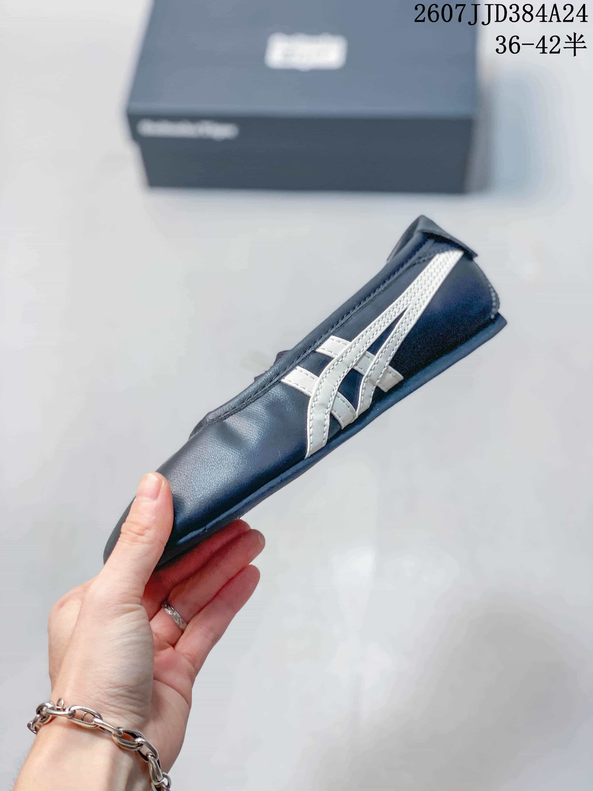 Side profile showing the dark navy upper, white side stripes, Mary Jane-style strap, and low outsole.