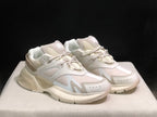 Three-quarter front view of the bone white sneakers showing the toe overlays, side panels and thick outsole.