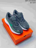 Charcoal Nike-branded low-top running shoes with teal accents on an orange shoebox