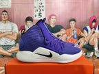 Side view of a purple Nike high-top basketball shoe with a black Swoosh and white sole