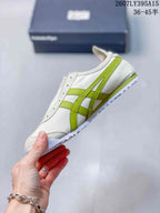 Side view highlighting the green Onitsuka Tiger side stripes and stitched white upper panels.