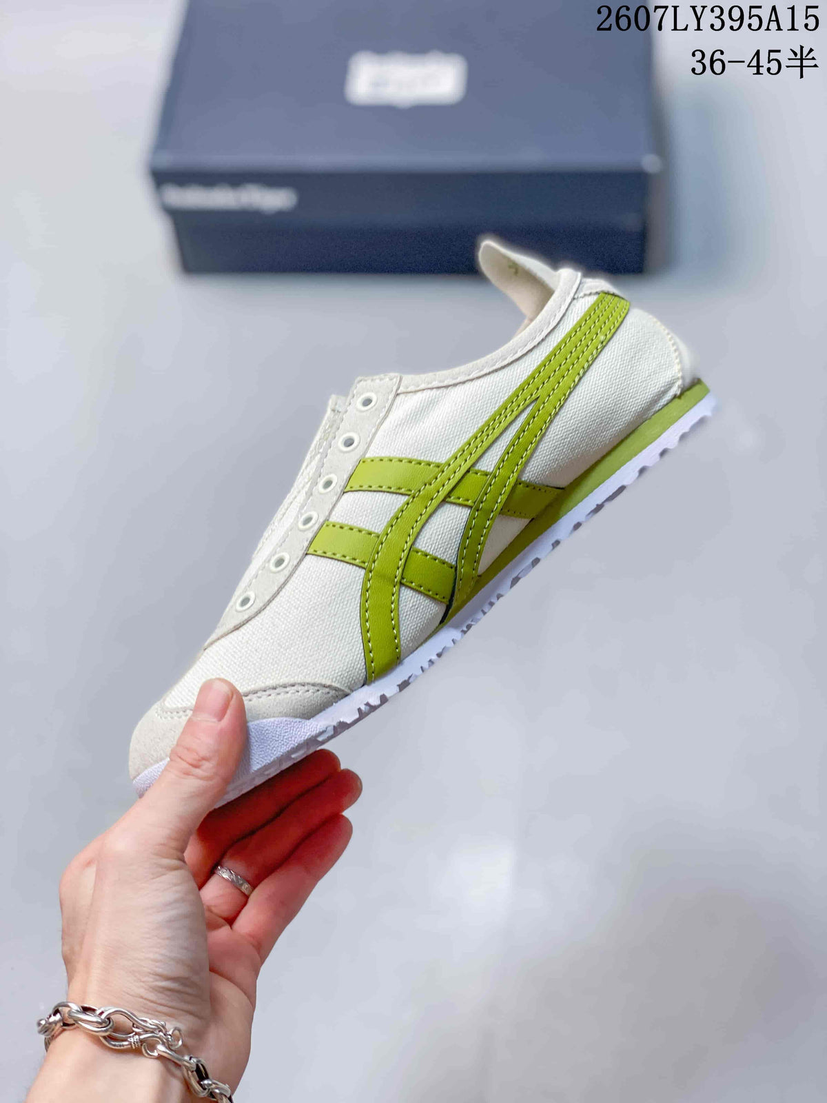 Side view highlighting the green Onitsuka Tiger side stripes and stitched white upper panels.