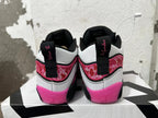 Rear view of black, white, and pink Jordan basketball sneakers with patterned heel panels