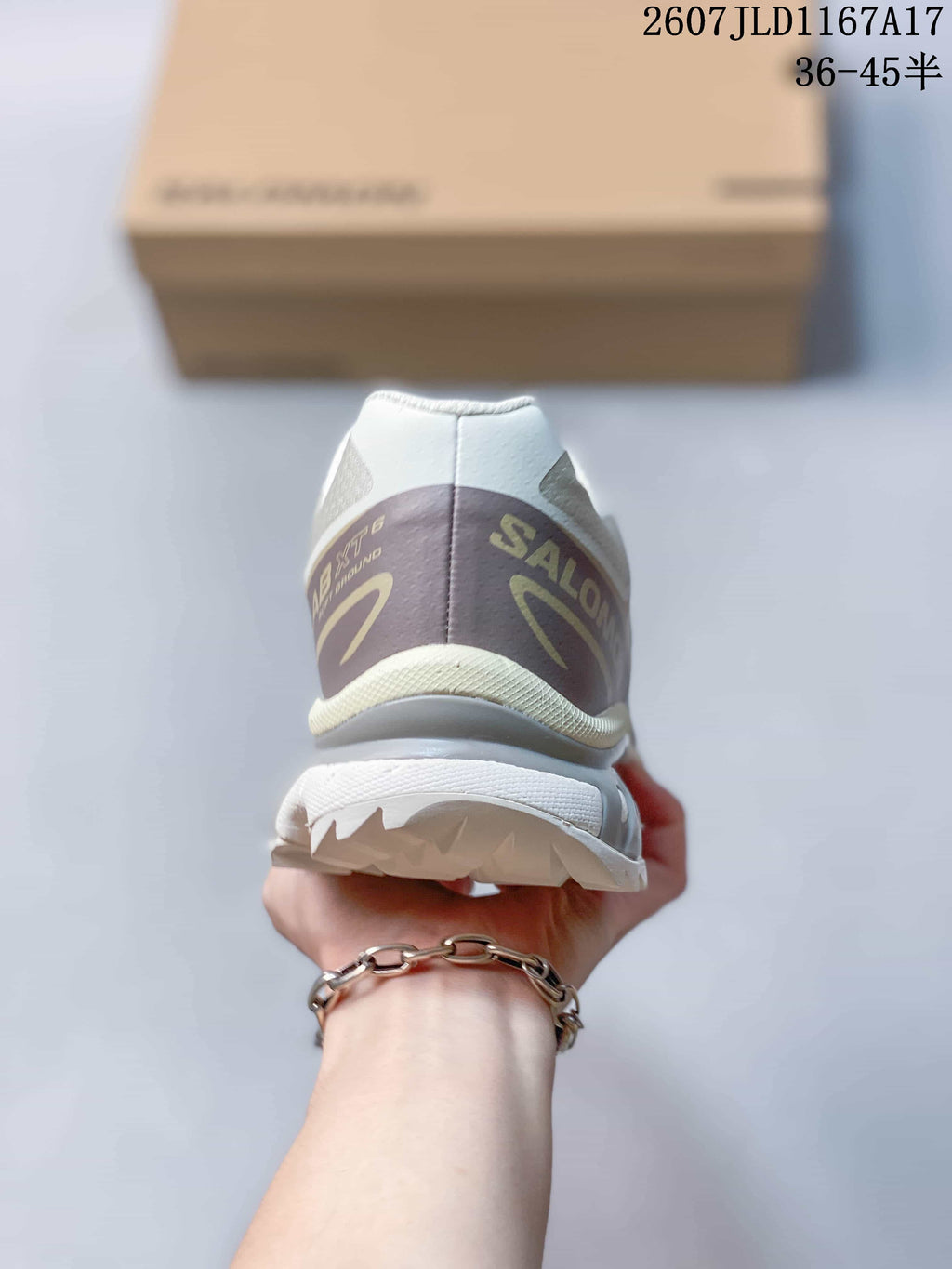 Rear view of the Salomon XT-6 showing the padded collar, heel branding, layered heel panel, and lugged outsole.