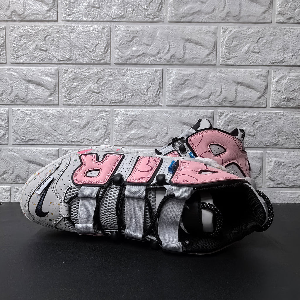 Top view of sneaker showing mesh tongue, black laces, and wide grey lace loops
