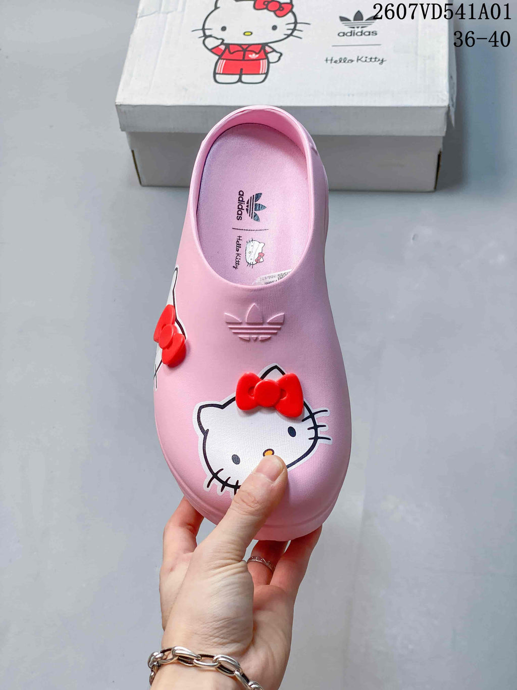 Top view of a pink Hello Kitty clog with red bows and adidas branding