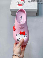 Top view of a pink Hello Kitty clog with red bows and adidas branding
