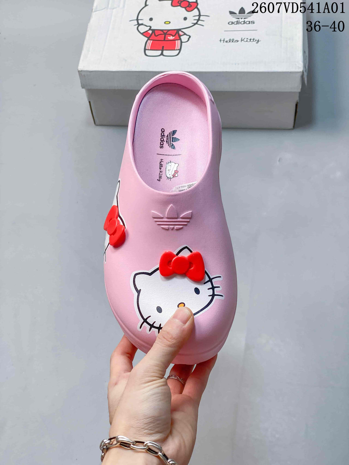 Top view of a pink Hello Kitty clog with red bows and adidas branding