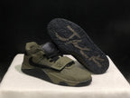 Angled view showing one sneaker outsole, textured tread, forefoot strap, and side detailing.