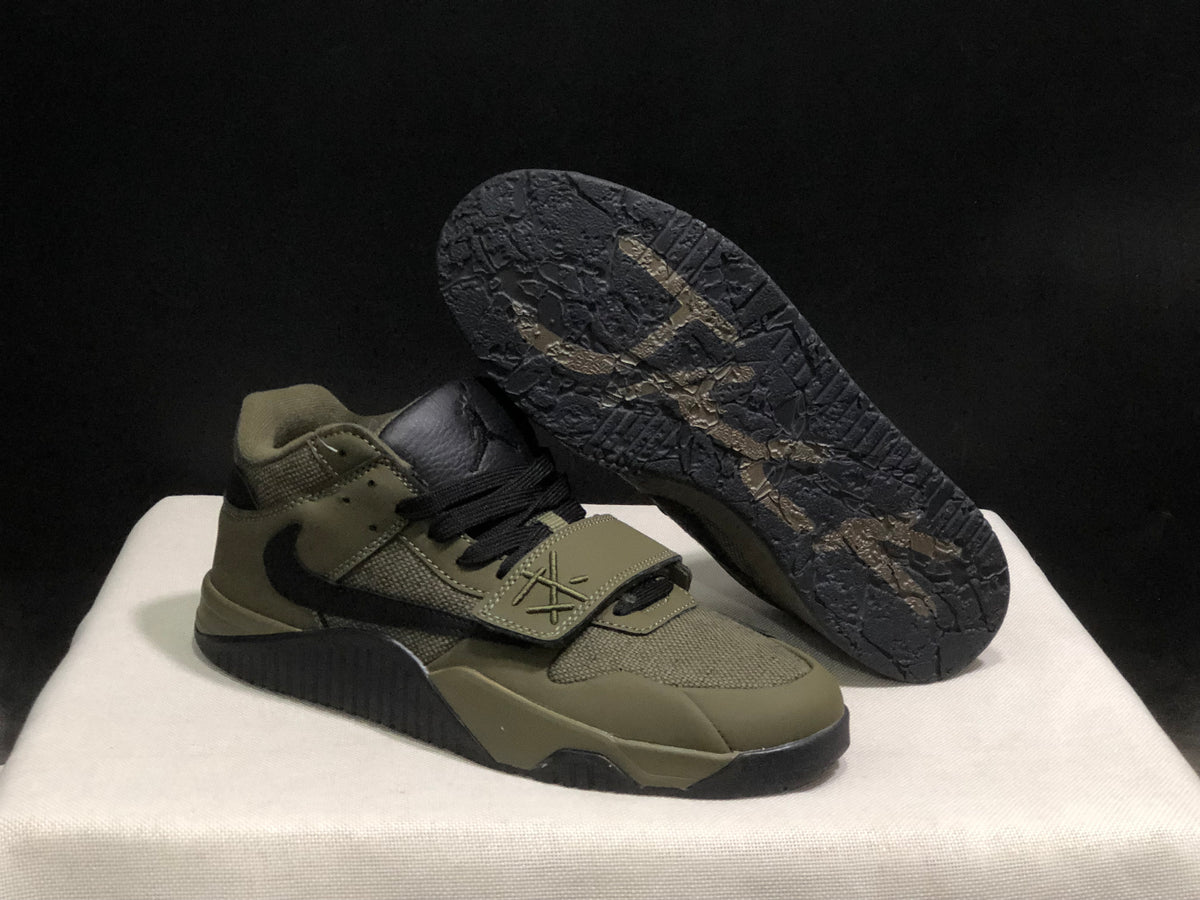 Angled view showing one sneaker outsole, textured tread, forefoot strap, and side detailing.