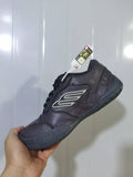 Angled view of a grey Skechers 1190 sneaker showing the side logo, lace-up front, padded collar and textured outsole.