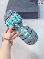 Underside view of a Nike Air Max 95 sneaker showing the dark outsole and turquoise central detail.