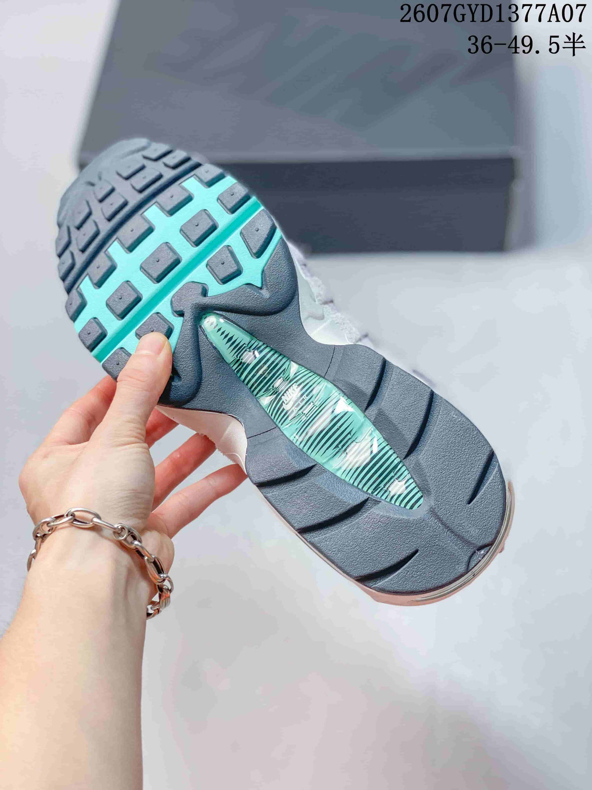 Underside view of a Nike Air Max 95 sneaker showing the dark outsole and turquoise central detail.