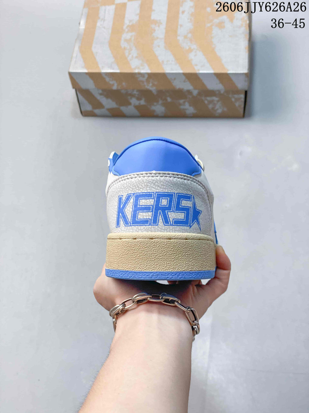 Rear view showing blue heel branding, blue collar lining, and a distressed beige-toned midsole.