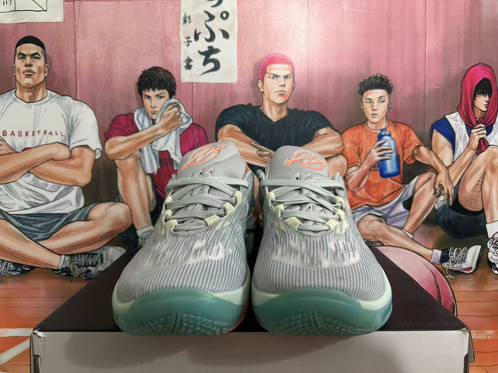 Front view showing the laces, patterned gray upper, and blue-green outsole