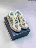 Pair of multicolor Onitsuka Tiger Delecity low-top sneakers displayed on a shoebox