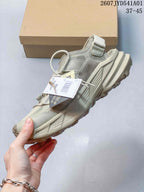 Side view of the beige Terrex shoe with mesh panels and layered sole