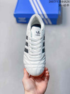 Top view of a white adidas Taekwondo sneaker with white laces, padded collar, stitched toe panels, and Trefoil tongue branding.