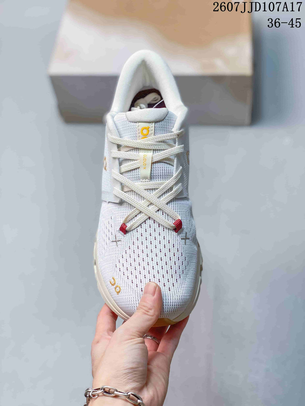 Top view showing the knit-style toe box, laces, tongue branding, and red lace details.