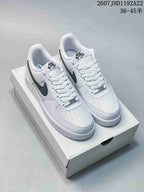 Pair of white and black Nike Air Force 1 Low '07 style sneakers displayed on a shoe box.