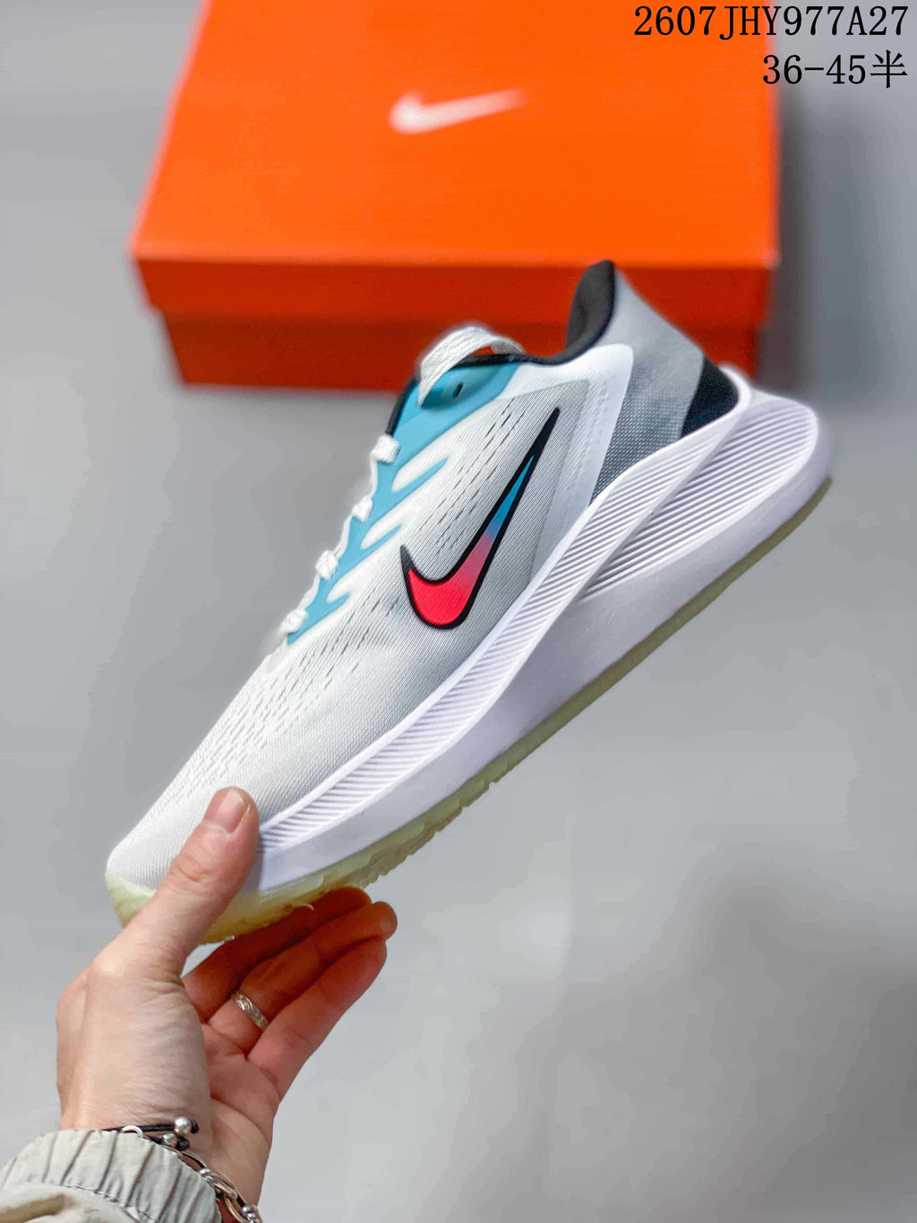 Side profile of the white low-top running shoe with blue and red side accents and a sculpted white midsole.