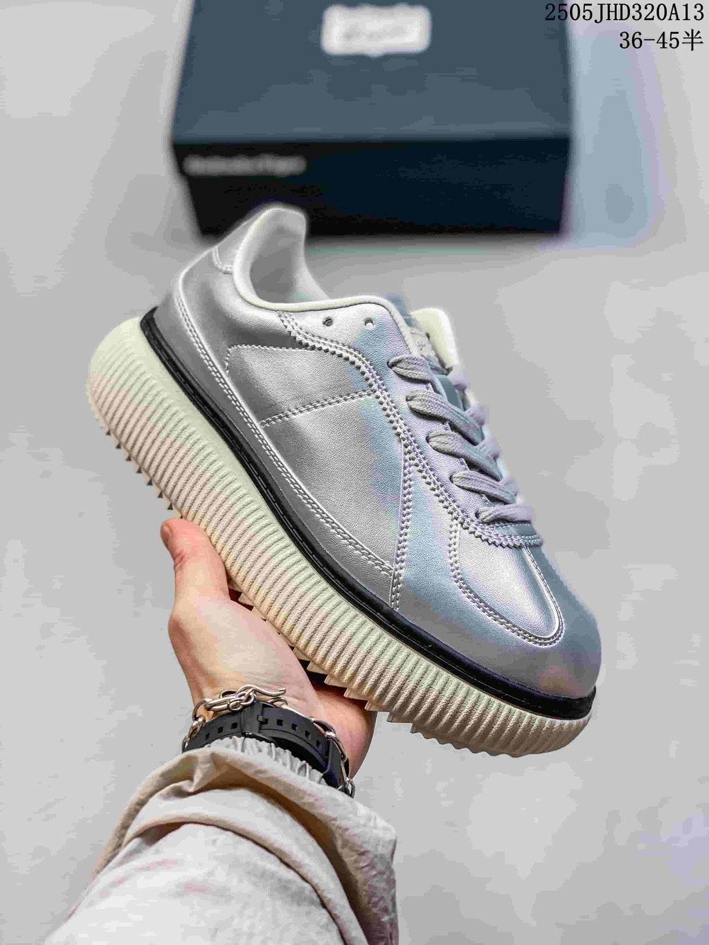 Angled side view of the silver sneaker and ribbed sole
