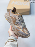 Angled side view of a brown and taupe SATISFY sneaker showing the layered upper, laces, heel, and sculpted outsole.