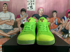 Front view of bright green low-top basketball shoes with matching laces