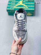 Top view showing patterned toe box, navy-and-white laces, white tongue, and dark tongue branding.