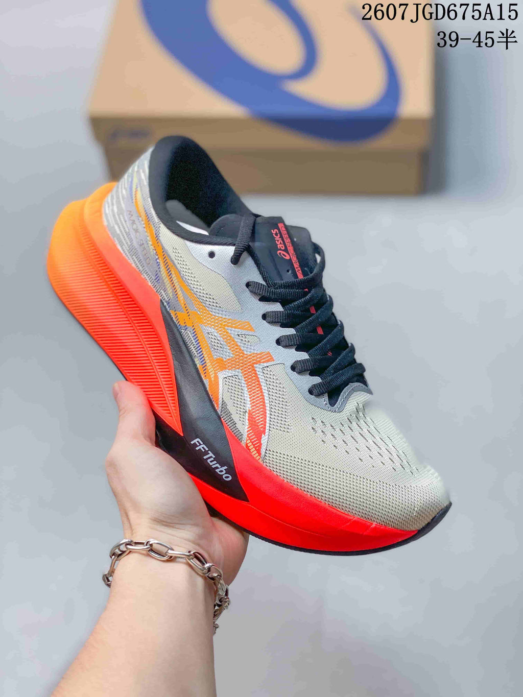 Light gray ASICS running shoe with orange and red accents, black laces, and a bright red midsole.
