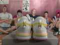 Rear view of white Nike basketball sneakers with yellow and pink accents