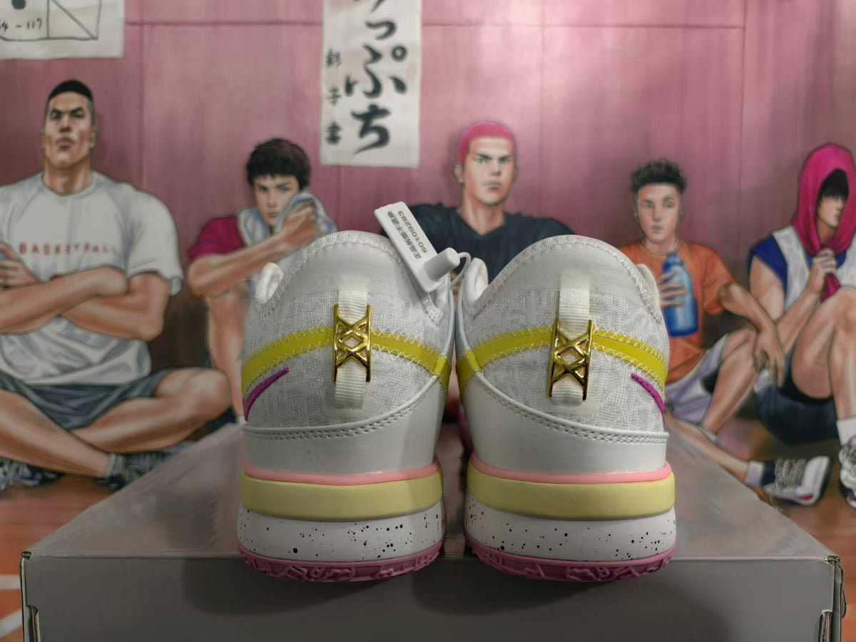 Rear view of white Nike basketball sneakers with yellow and pink accents