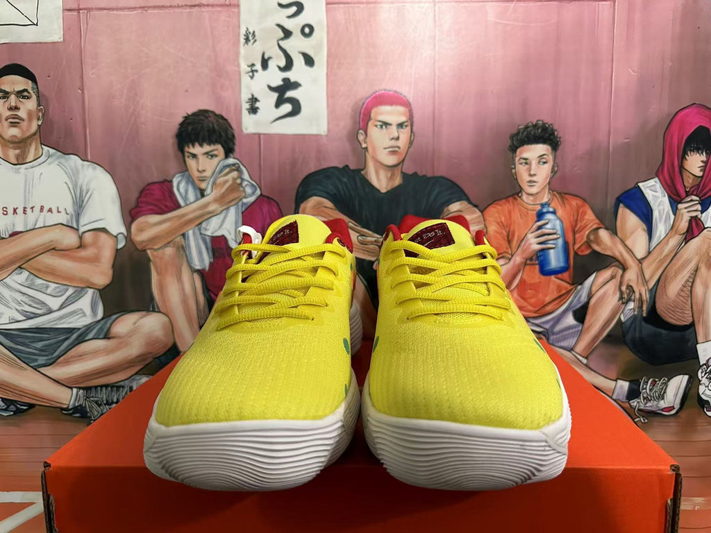 Front view showing the yellow uppers, yellow laces, red tongue details, and white textured outsoles.