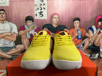 Front view showing the yellow uppers, yellow laces, red tongue details, and white textured outsoles.