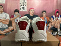 Rear view of white sneakers with glossy red heel panels and a sculpted outsole