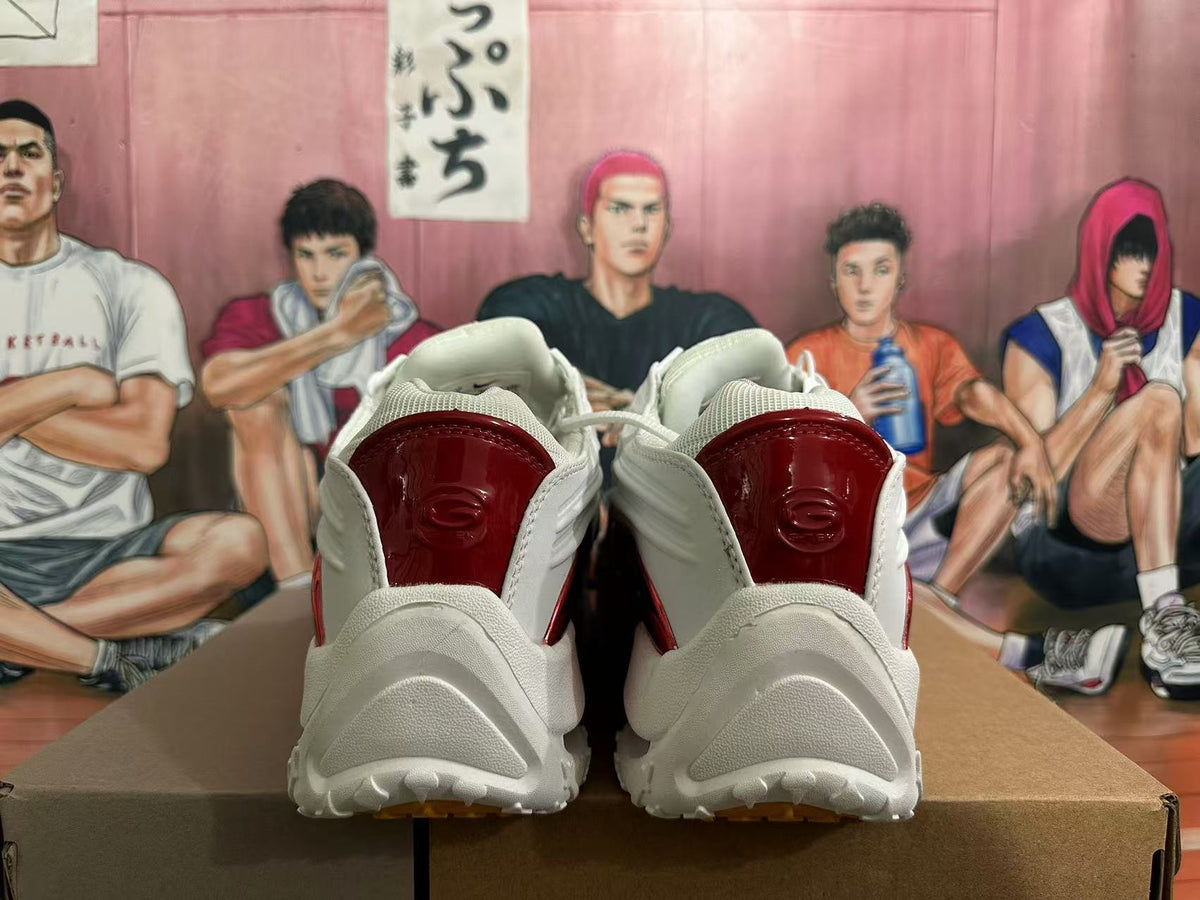 Rear view of white sneakers with glossy red heel panels and a sculpted outsole