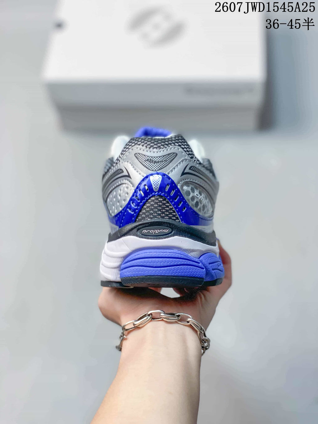 Rear view of the sneaker showing the blue heel accent, layered heel structure and ProGrid branding.