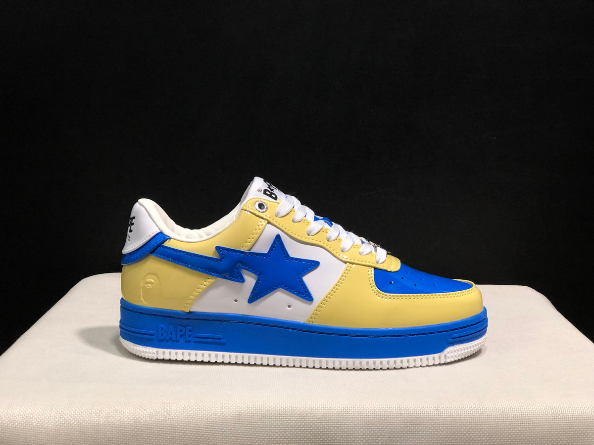 Single side profile of the blue and yellow BAPE STA sneaker