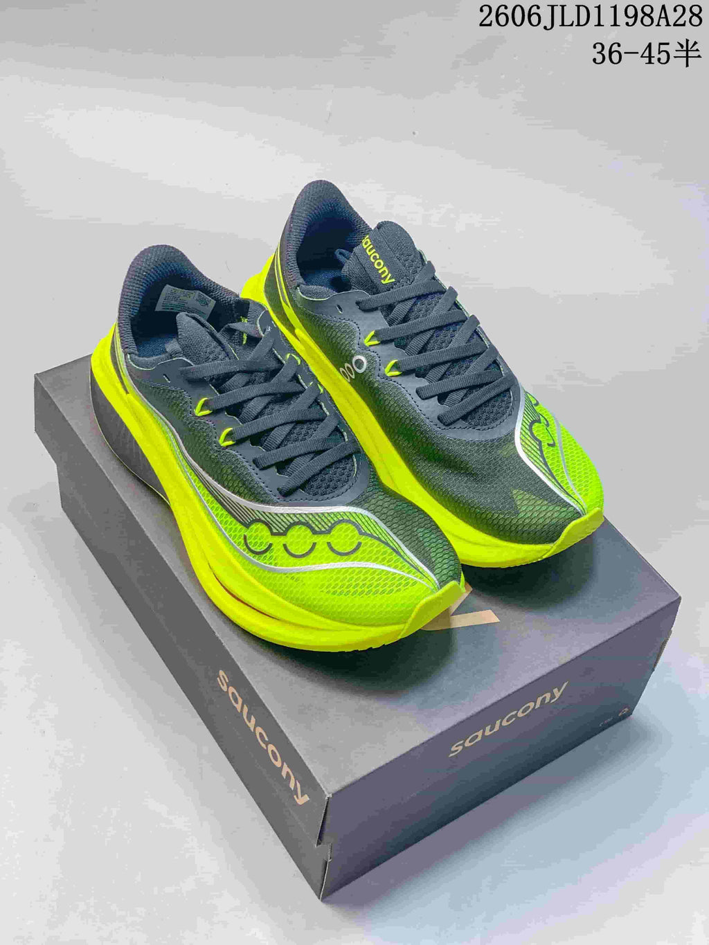 Pair of dark gray and volt-yellow Saucony Endorphin Speed 5 running shoes on a shoebox