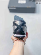 Rear view showing the layered heel panels and speckled midsole.