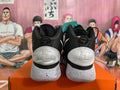 Rear view of black and white Nike Hyperdunk basketball shoes with speckled outsoles