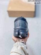 Rear view of the dark gray sneaker showing the padded heel, On branding, and sculpted outsole.