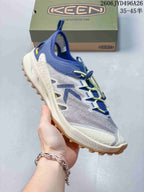 Side view of a white and blue Keen Zionic ADV hiking shoe with yellow quick-lacing cords