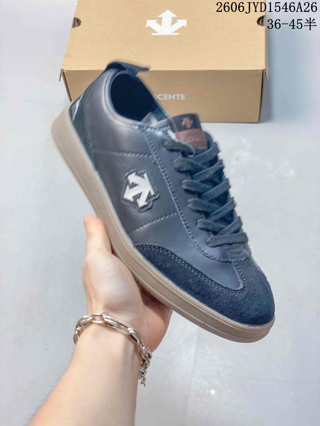 Close-up of a dark navy sneaker showing the side emblem and lace-up design