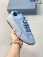 Angled side view of the light blue PUMA Speedcat sneaker showing the side stripe, logo, laces, and gum outsole.