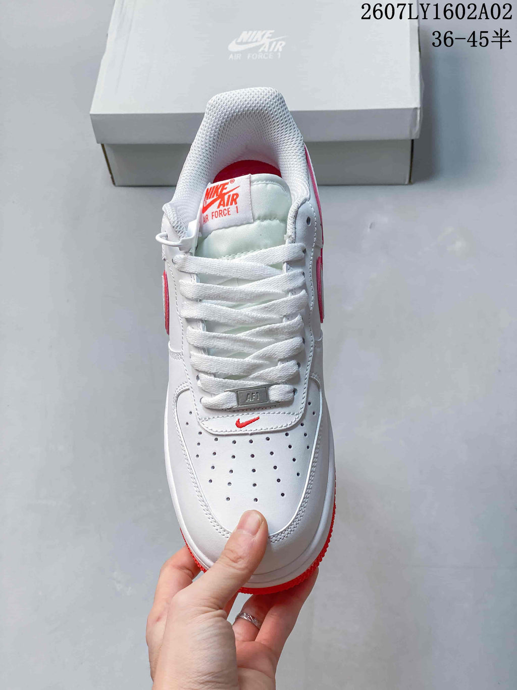 Top view of a white Nike Air Force 1 ’07 sneaker showing its laces and perforated toe.
