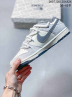 Side profile highlighting the gray Swoosh, white and gray panels, and dark outsole.